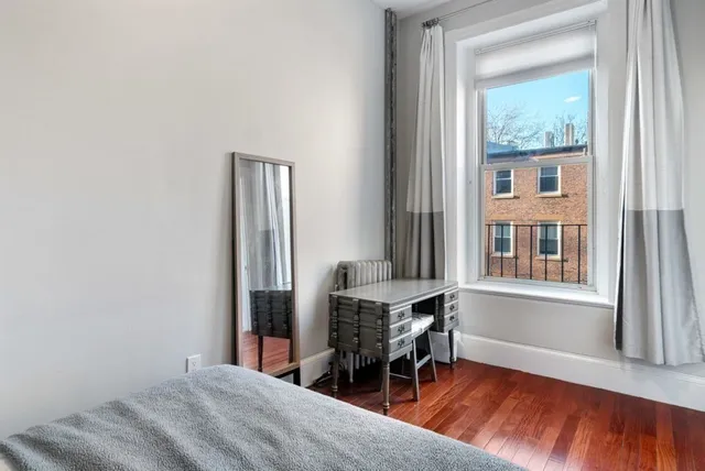 a bedroom with a bed and a window