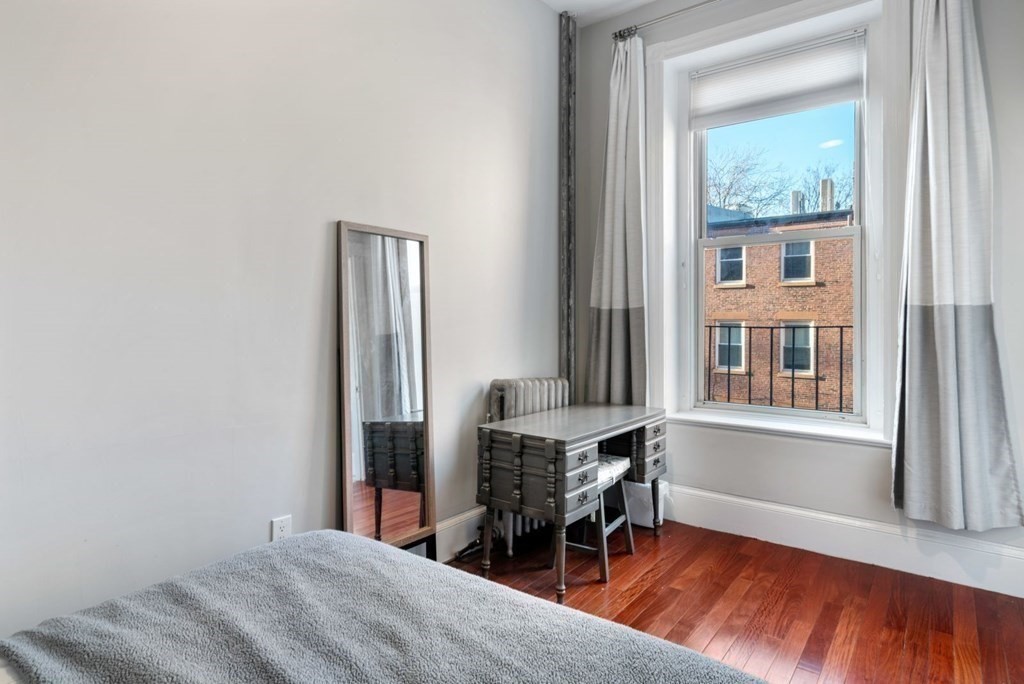 1411 Washington Street, Unit 5 Boston, MA 02118 - Photo 12 of 19 a bedroom with a bed and a window