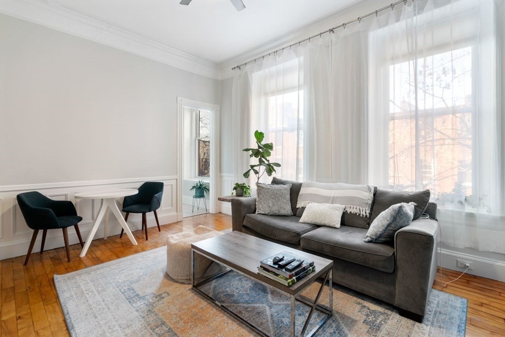 1411 Washington Street, Unit 5 Boston, MA 02118 - Photo 4 of 19 a living room with furniture and a large window
