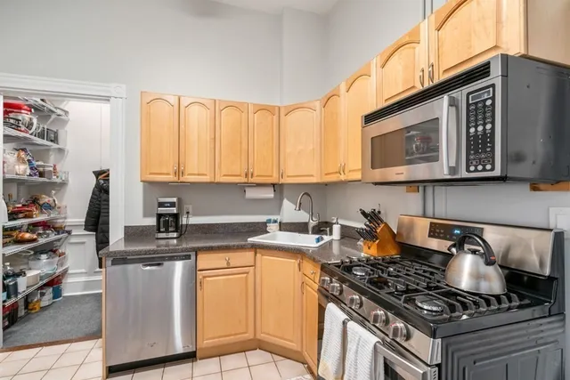 a kitchen with stainless steel appliances granite countertop a stove and a microwave