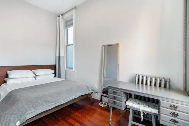 a bedroom with a bed and a chair