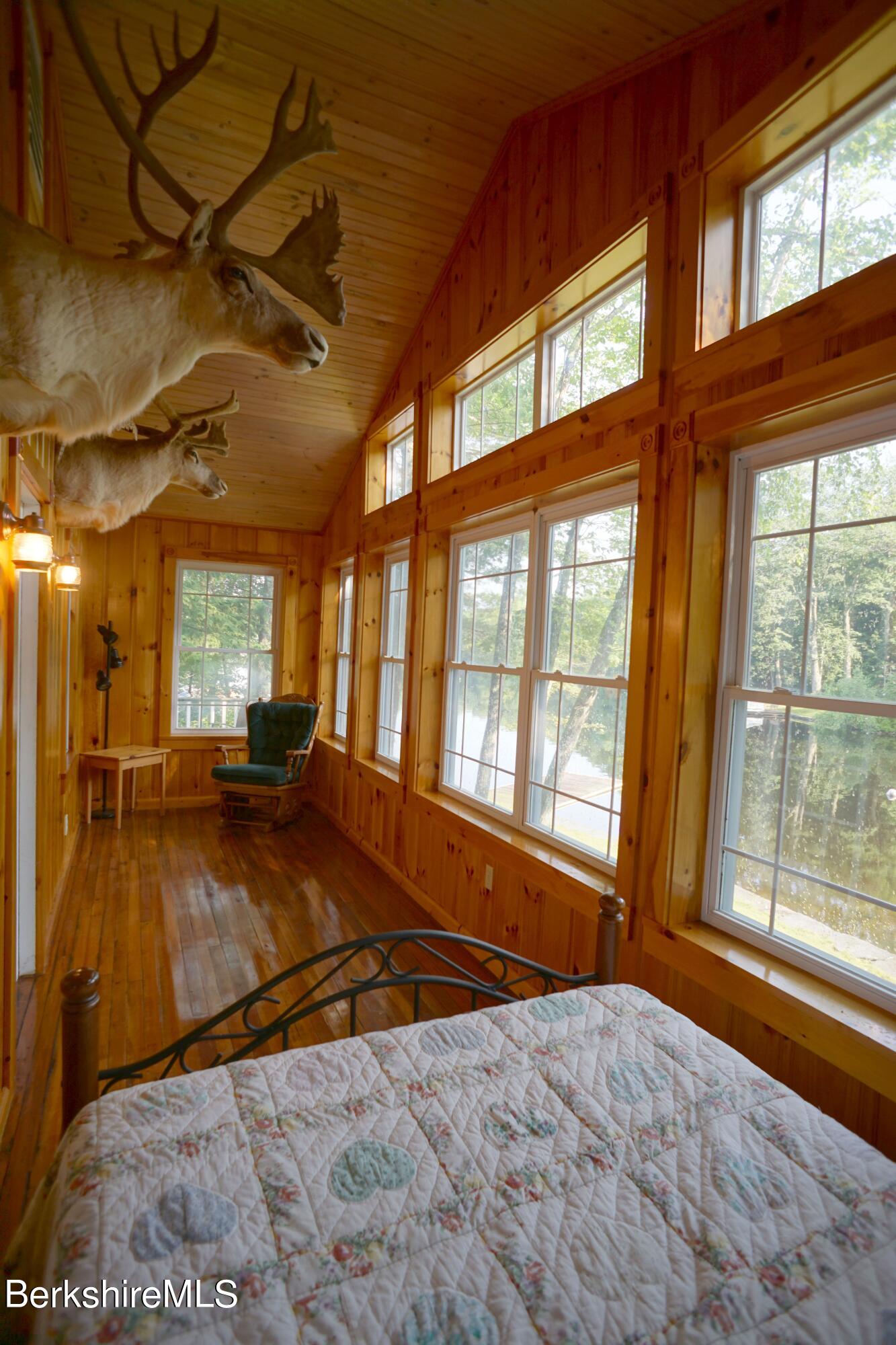5 South Gate Island Road Otis, MA 01029 - Photo 13 of 38 a view of an empty room with a fireplace and a large window