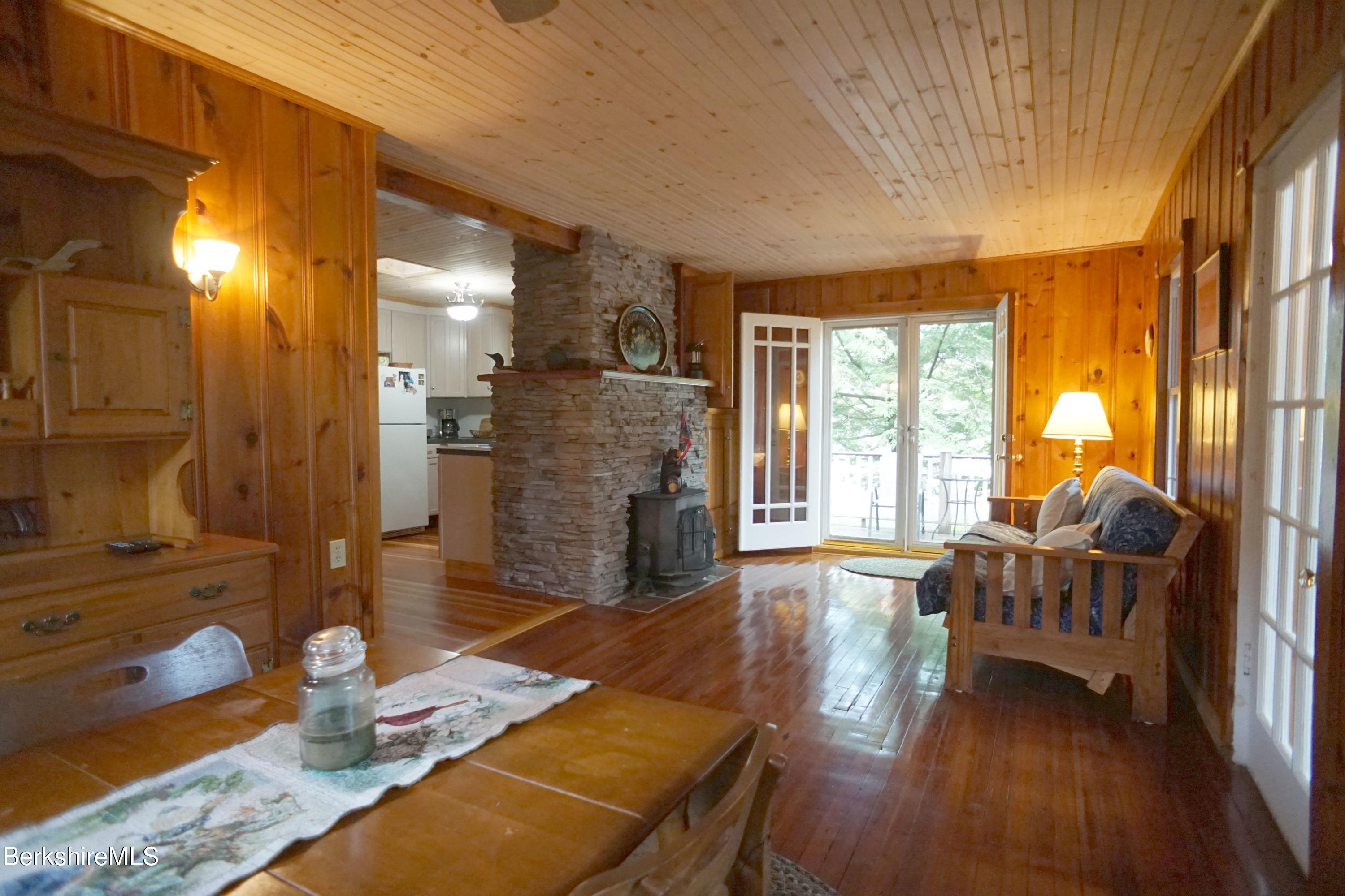 5 South Gate Island Road Otis, MA 01029 - Photo 18 of 38 a living room with furniture and a fireplace
