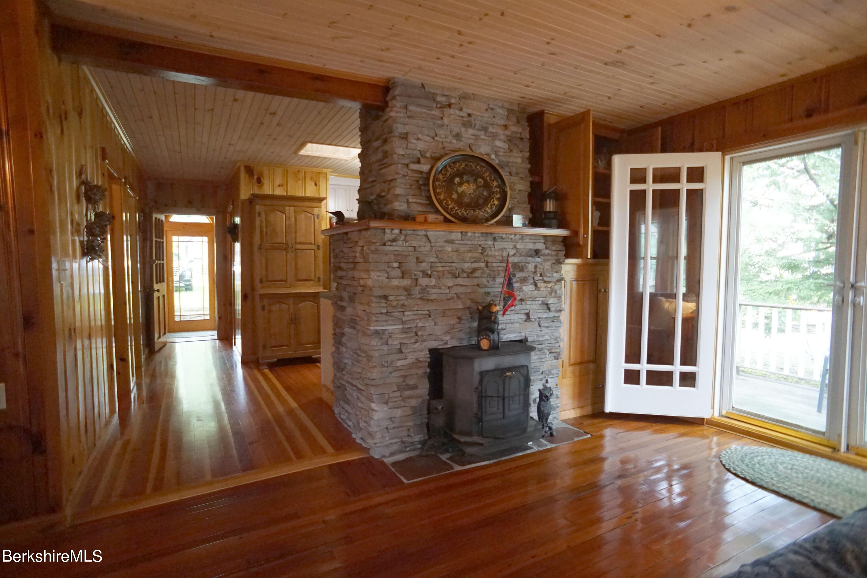 5 South Gate Island Road Otis, MA 01029 - Photo 19 of 38 a view of a livingroom with wooden floor and a fireplace