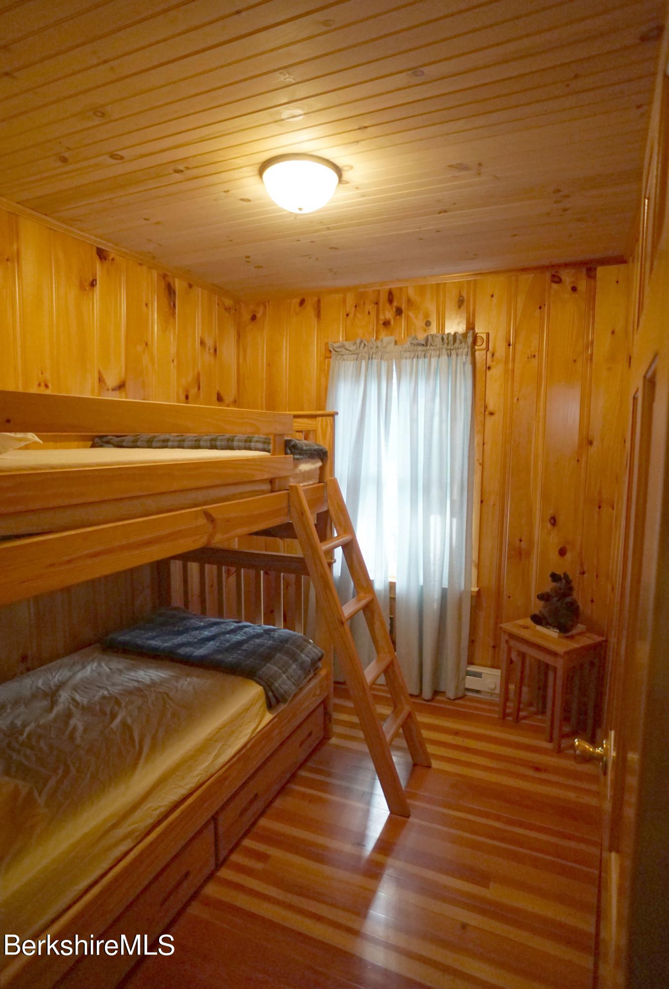 5 South Gate Island Road Otis, MA 01029 - Photo 22 of 38 a view of a balcony with furniture and wooden floor