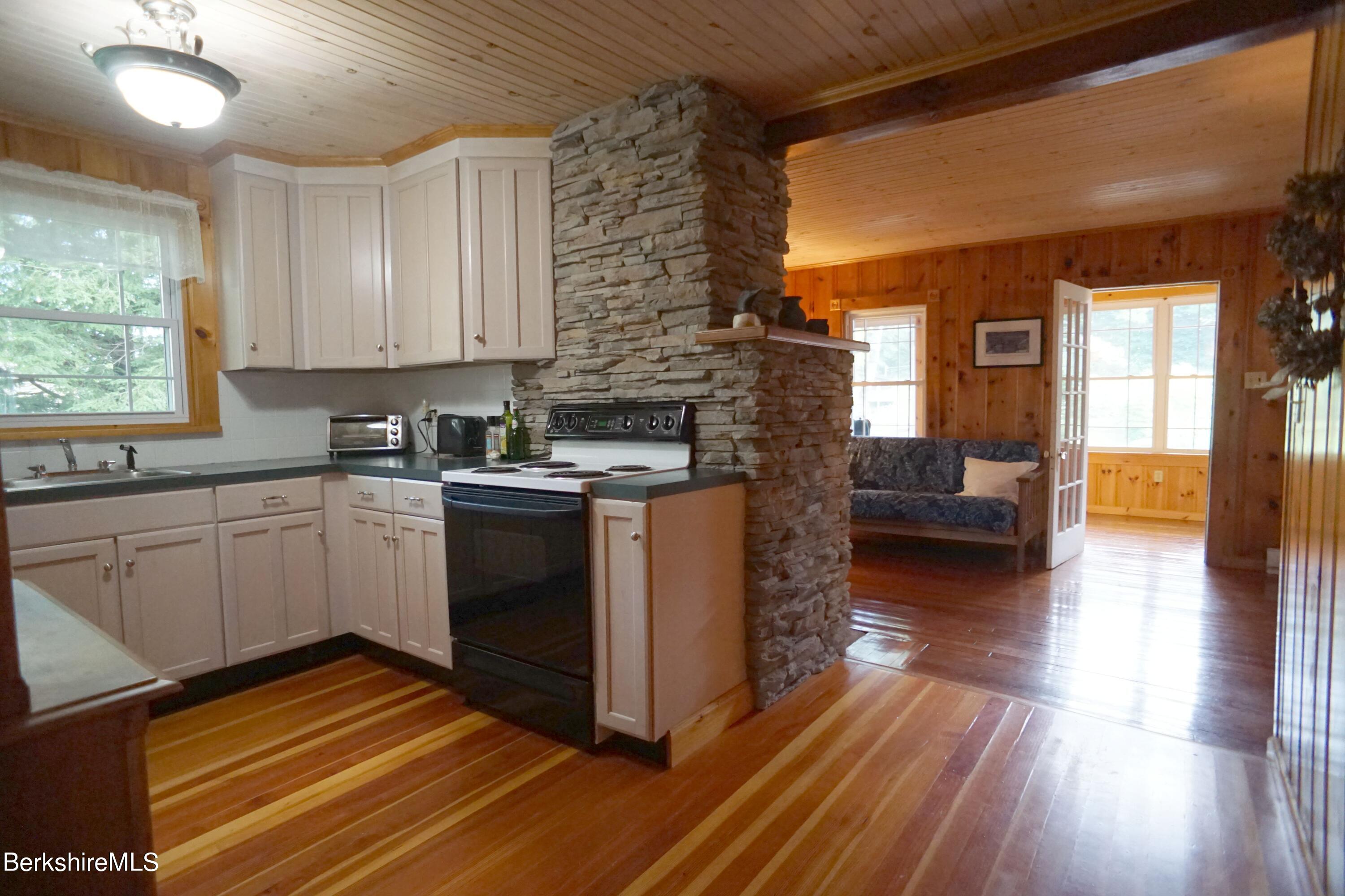 5 South Gate Island Road Otis, MA 01029 - Photo 23 of 38 a kitchen with a sink stove and cabinets