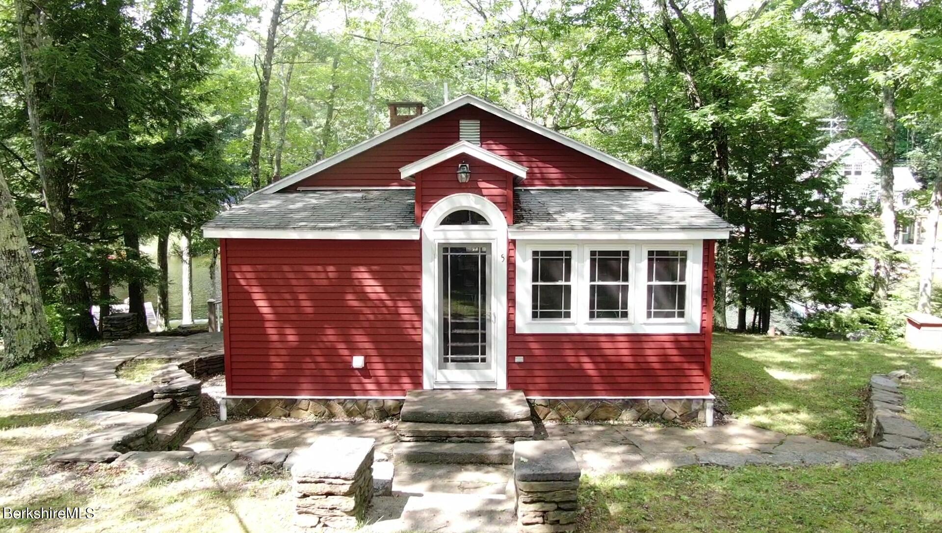 5 South Gate Island Road Otis, MA 01029 - Photo 3 of 38 a front view of a house with a yard