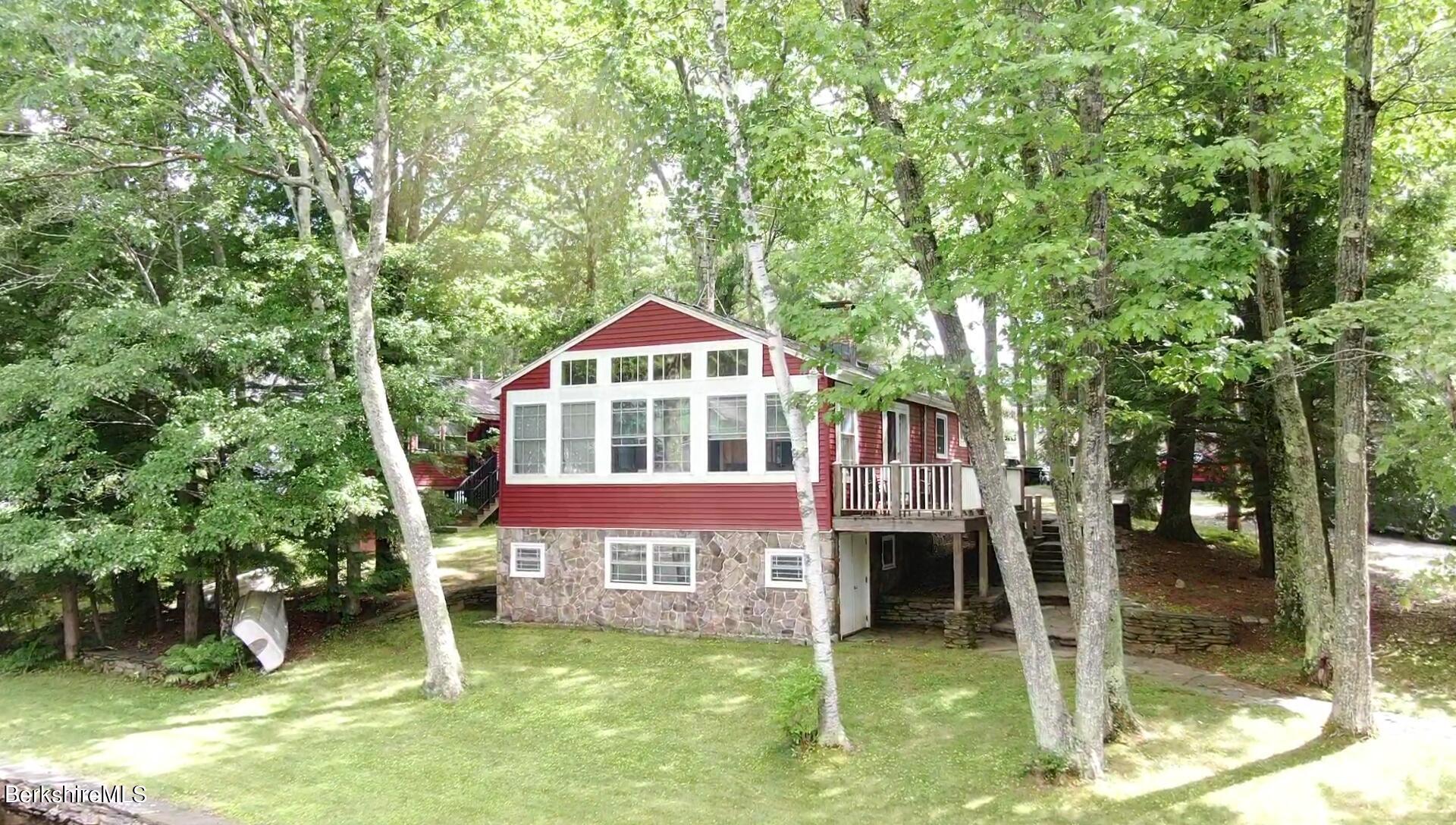 5 South Gate Island Road Otis, MA 01029 - Photo 33 of 38 a front view of a house with a yard garage and outdoor seating