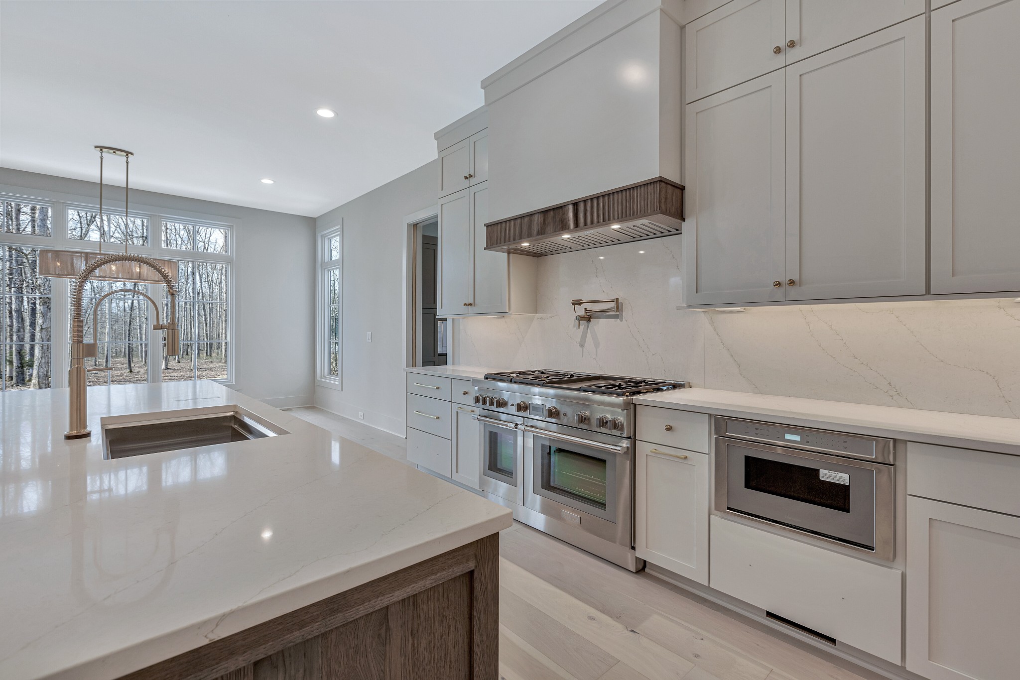 5025 Cobbler Ridge Road Franklin, TN 37064 - Photo 11 of 34 a kitchen with stainless steel appliances granite countertop a stove a sink and a microwave