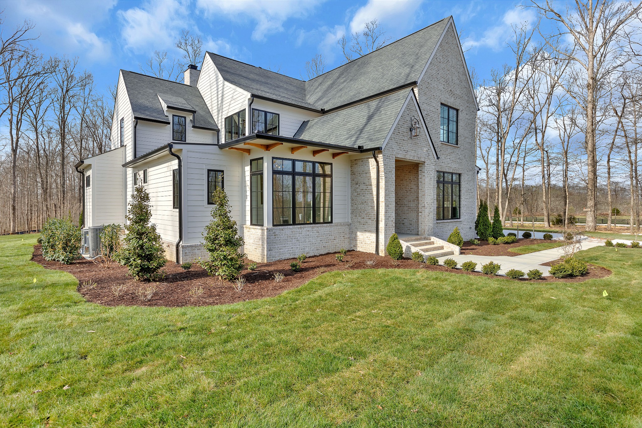 5025 Cobbler Ridge Road Franklin, TN 37064 - Photo 2 of 34 a view of a white house with a big yard and potted plants
