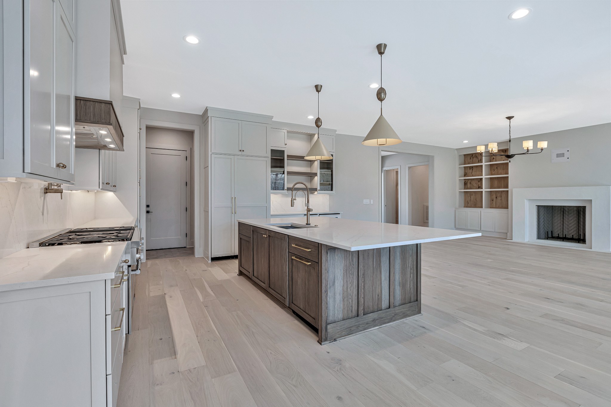 5025 Cobbler Ridge Road Franklin, TN 37064 - Photo 9 of 34 a kitchen with kitchen island a stove a sink a refrigerator and a wooden floor