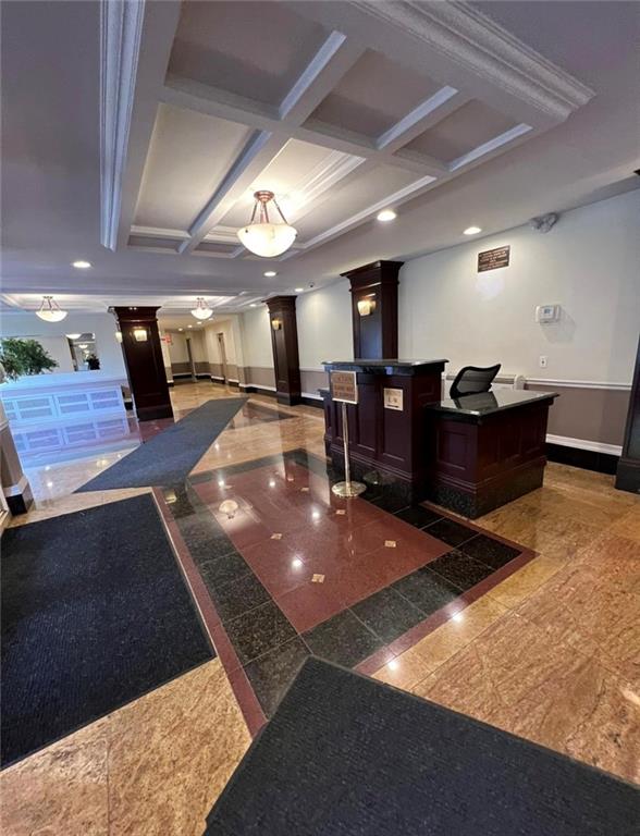 a lobby with furniture and a rug