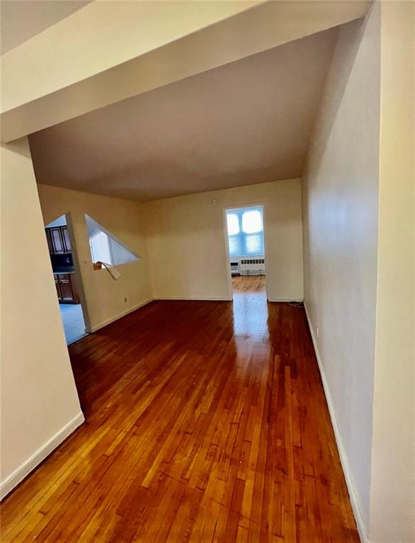 1237 Avenue Z, Unit 1V Brooklyn, NY 11235 - Photo 5 of 20 a view of an empty room with wooden floor and a window