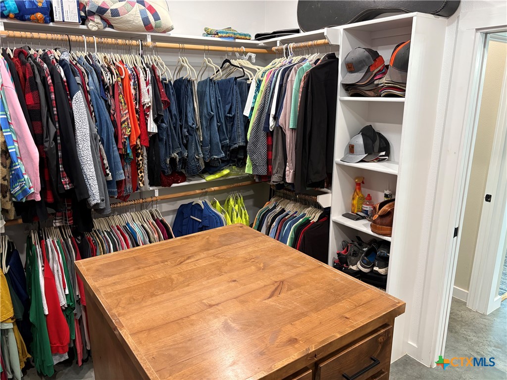 5851 Moccasin Bend Road Gatesville, TX 76528 - Photo 26 of 48 a view of walk in closet with clothes and shoes