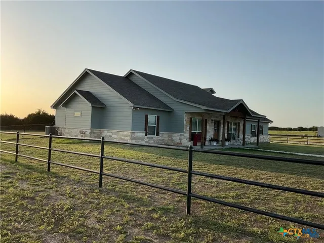 a living room with lots of furniture and kitchen view