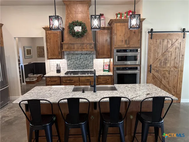 a view of walk in closet with clothes