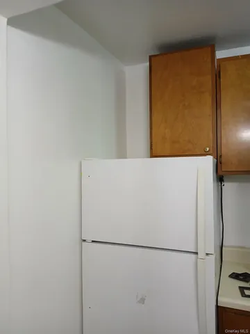 a white refrigerator freezer sitting in a kitchen