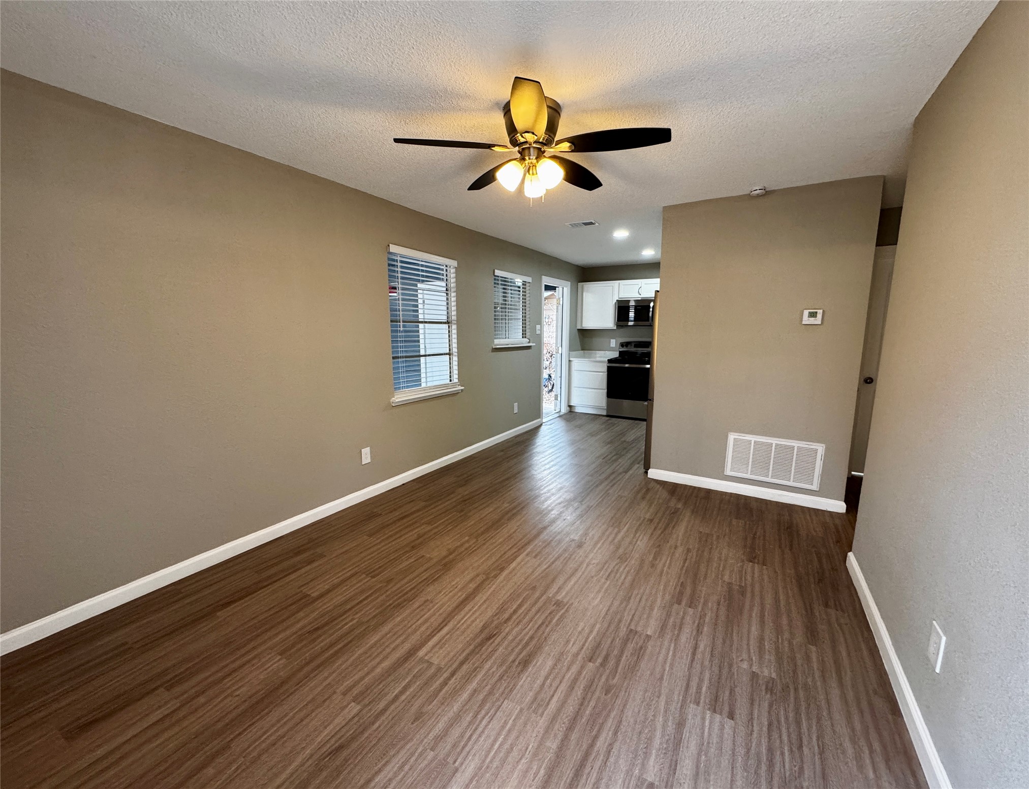 202 West N Loop Boulevard, Unit B Austin, TX 78751 - Photo 3 of 7 a view of an empty room with wooden floor and a window