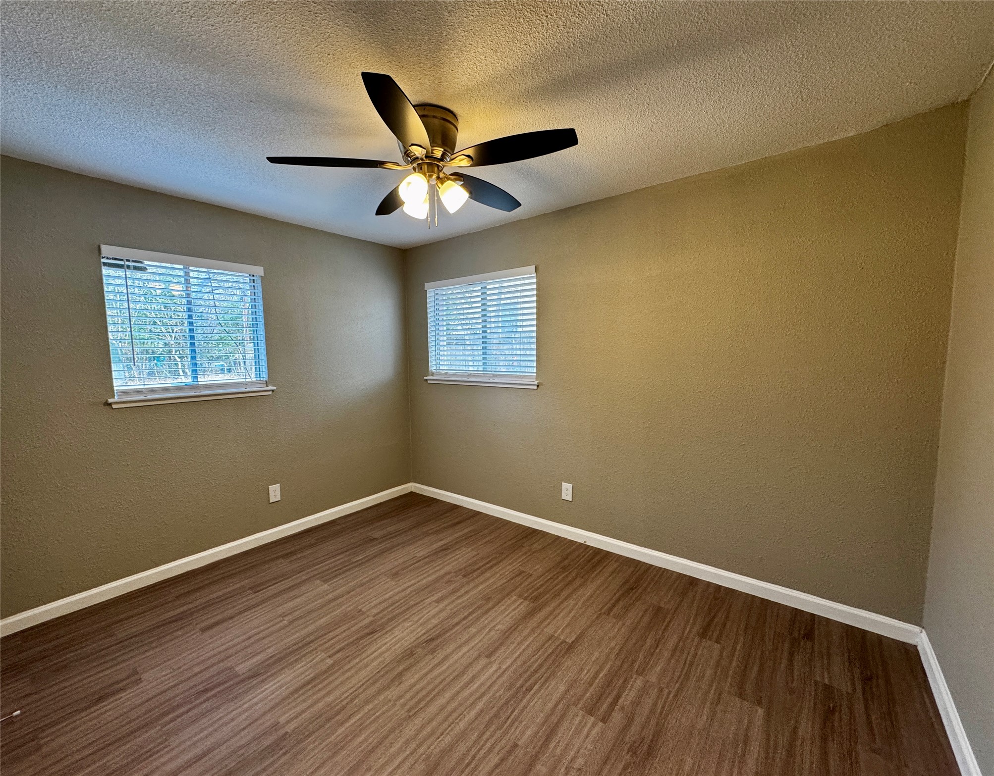 202 West N Loop Boulevard, Unit B Austin, TX 78751 - Photo 5 of 7 a view of an empty room with wooden floor and a window