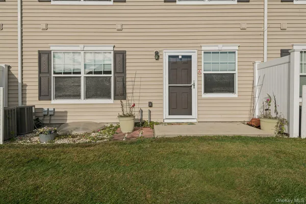 a front view of a house with a garden and yard