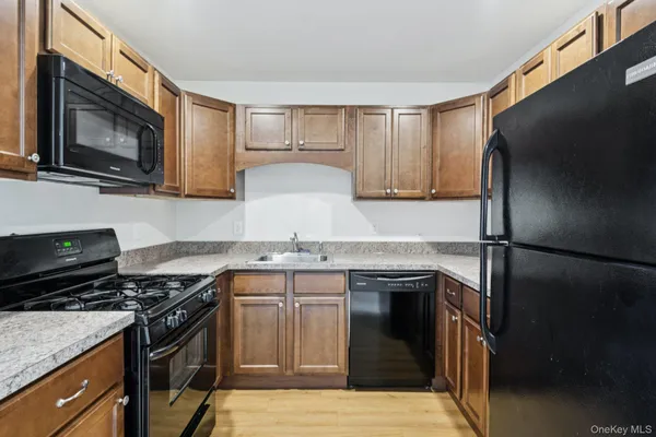 a kitchen with a sink stove and refrigerator
