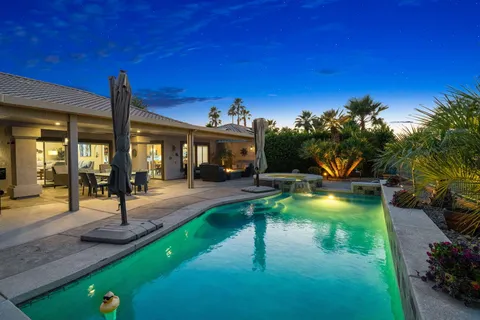 a view of a patio with table and chairs a fire pit and yard