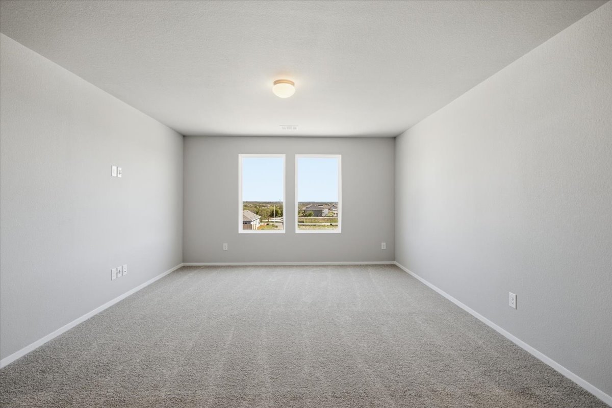 2714 Foss Road Manor, TX 78653 - Photo 23 of 34 Double windows frame far-reaching neighborhood views in this spacious, carpeted room.