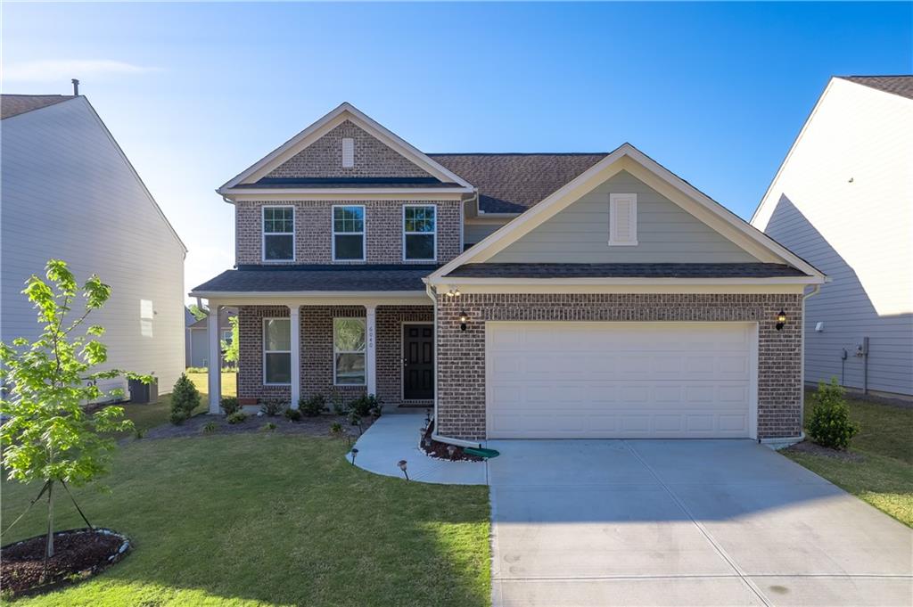 6040 Wheeler Ridge Road Auburn, GA 30011 - Photo 1 of 1 a front view of a house with garden