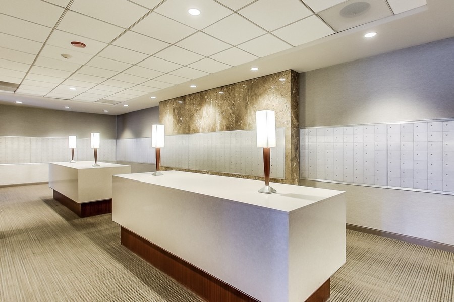 655 West Irving Park Road, Unit 5202 Chicago, IL 60613 - Photo 14 of 26 a large kitchen with kitchen island a sink stainless steel appliances and cabinets