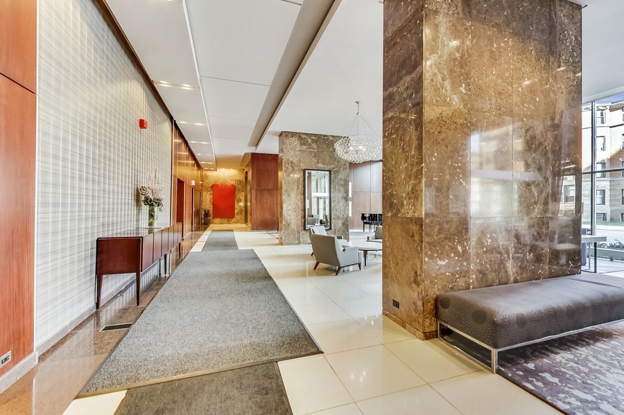 655 West Irving Park Road, Unit 5202 Chicago, IL 60613 - Photo 17 of 26 a spacious bedroom with a balcony a bed and a couch