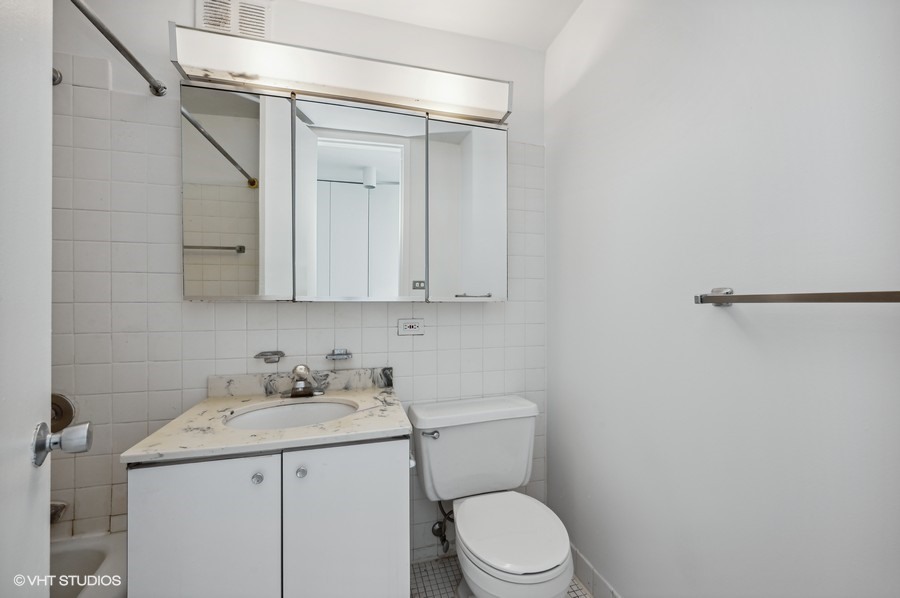655 West Irving Park Road, Unit 5202 Chicago, IL 60613 - Photo 7 of 26 a bathroom with a sink a toilet and vanity