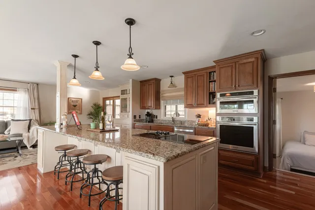 a kitchen with stainless steel appliances granite countertop a stove refrigerator and cabinets