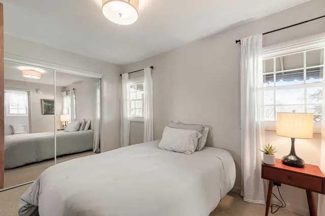 a bedroom with a bed and a lamp on table