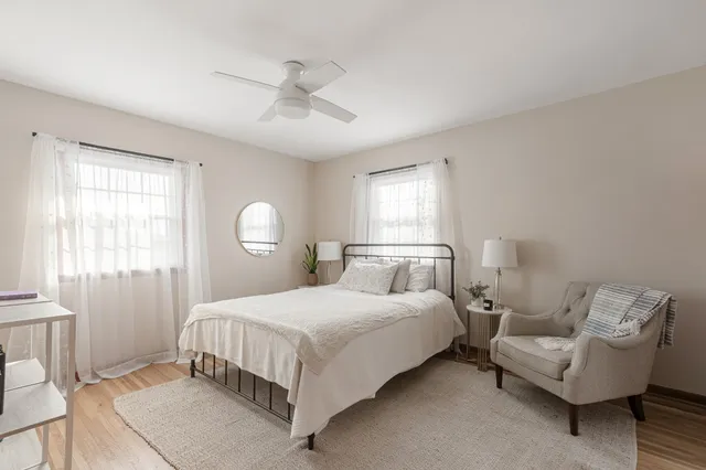 a bedroom with a bed couch and window