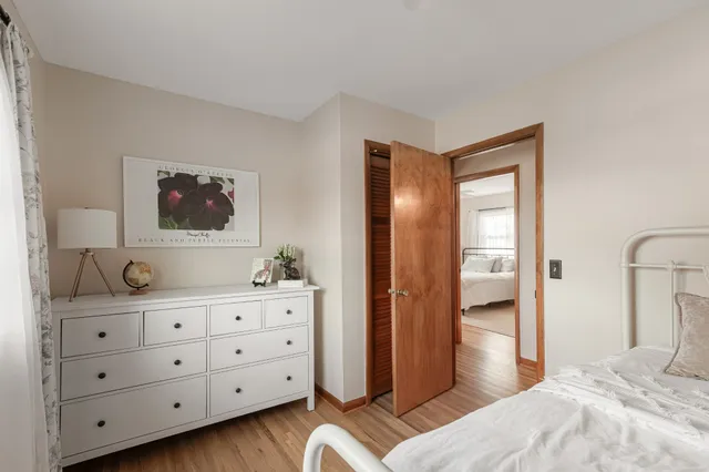 a bedroom with a bed and a dresser in it