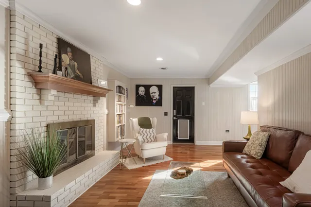 a living room with furniture fireplace and window