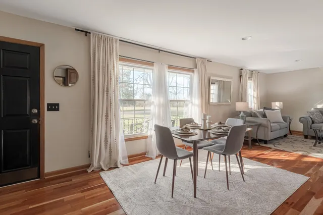a dining room with furniture and wooden floor