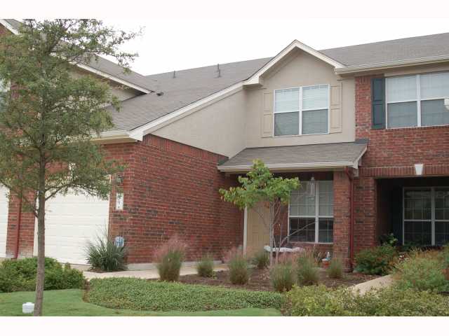79 Verde Ranch Loop Leander, TX 78641 - Photo 1 of 1 a view of a house with brick walls and a yard