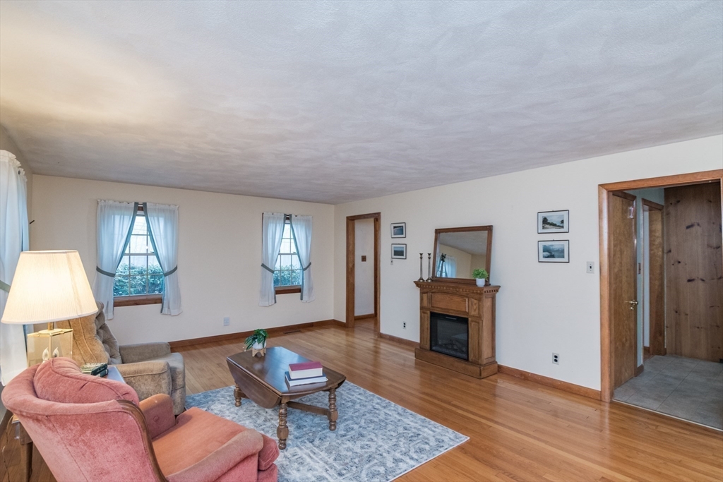 88 Buffam Road Pelham, MA 01002 - Photo 8 of 42 a living room with furniture and a fireplace