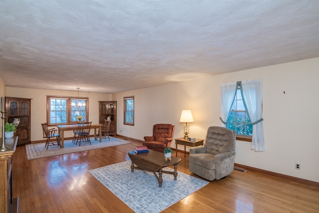 88 Buffam Road Pelham, MA 01002 - Photo 10 of 42 a living room with furniture and a wooden floor