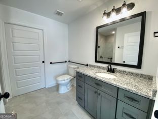 1333 Mooty Bridge Road, Unit 2 LaGrange, GA 30240 - Photo 7 of 17 a bathroom with a granite countertop toilet sink and a mirror