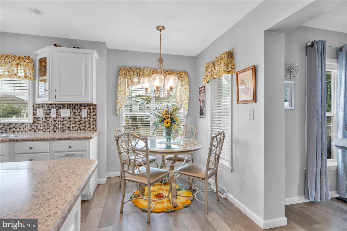 2012 Ocean Lane Williamstown, NJ 08094 - Photo 13 of 31 a view of a dining room with furniture a chandelier and wooden floor