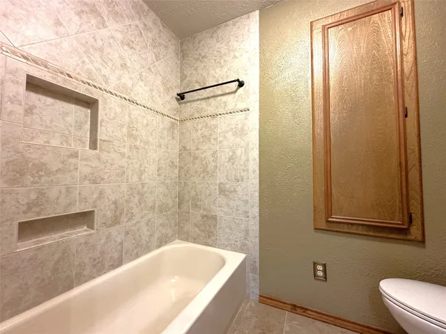 a bathroom with a bathtub and shower