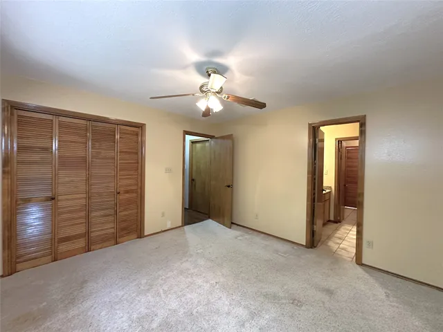a view of a livingroom with a chandelier fan
