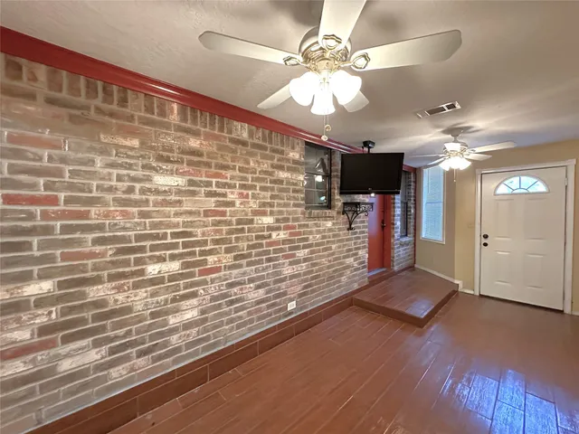 a view of a livingroom with a hall and a ceiling fan