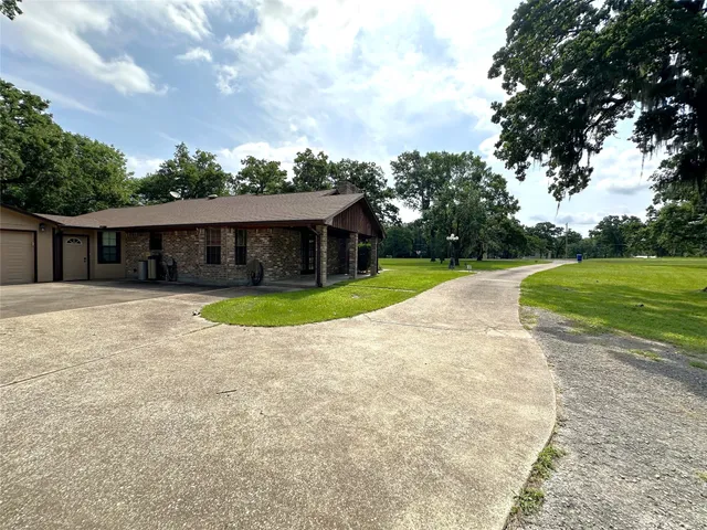 a view of swimming pool with outdoor seating and house in the background