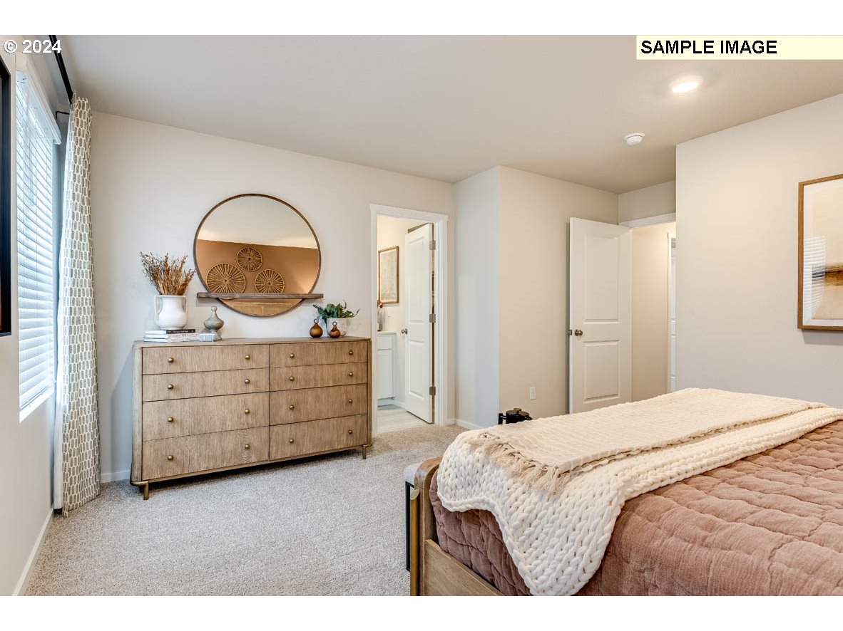 821 Northeast 174th Street Ridgefield, WA 98642 - Photo 21 of 25 a bedroom with a bed and a dresser
