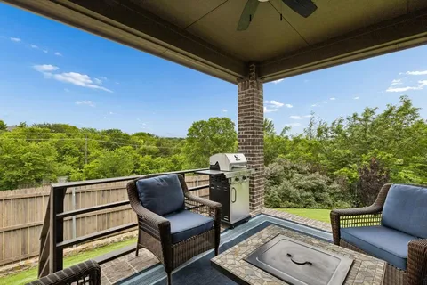 a view of a chairs and table in the balcony