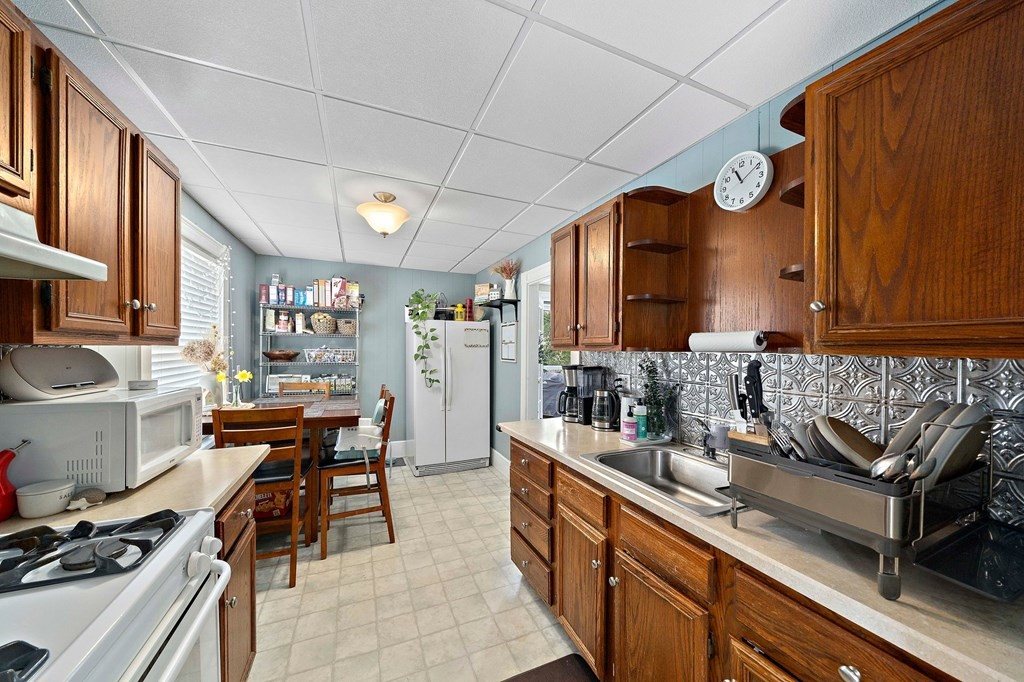 273 Wareham Street Middleboro, MA 02346 - Photo 27 of 42 a kitchen with stainless steel appliances granite countertop sink stove and cabinets