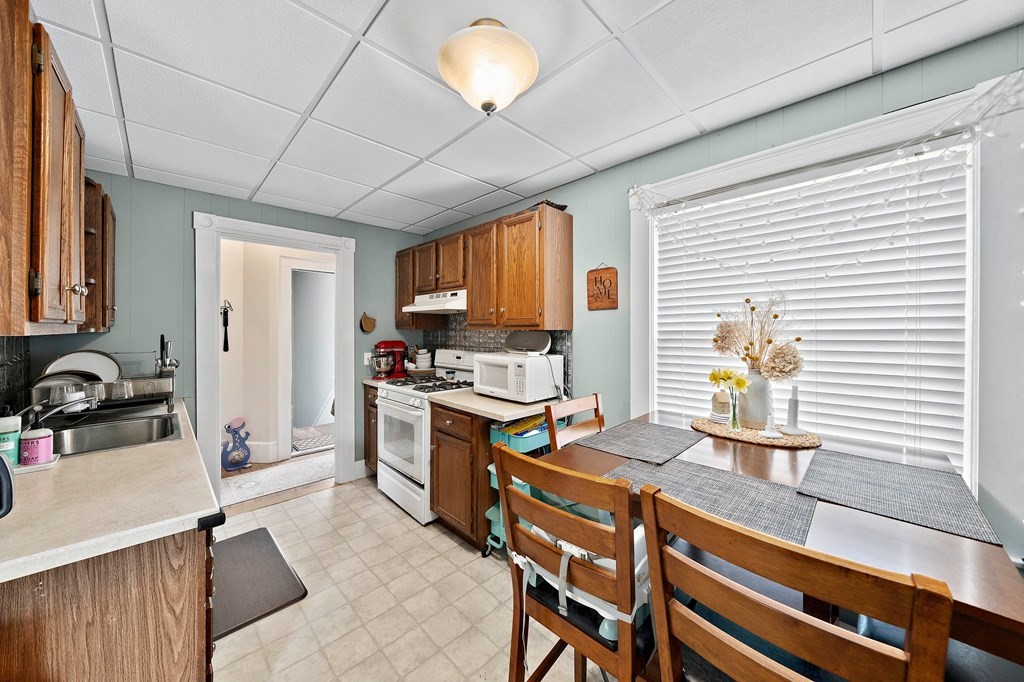 273 Wareham Street Middleboro, MA 02346 - Photo 28 of 42 a kitchen with a stove a sink and a refrigerator